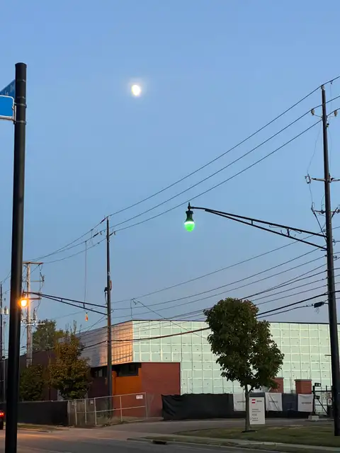 Moon above, green glow below.